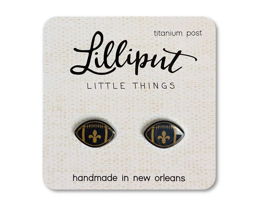 Lilliput Little Things black and gold fleur football stud earrings with hypoallergenic titanium posts on display card