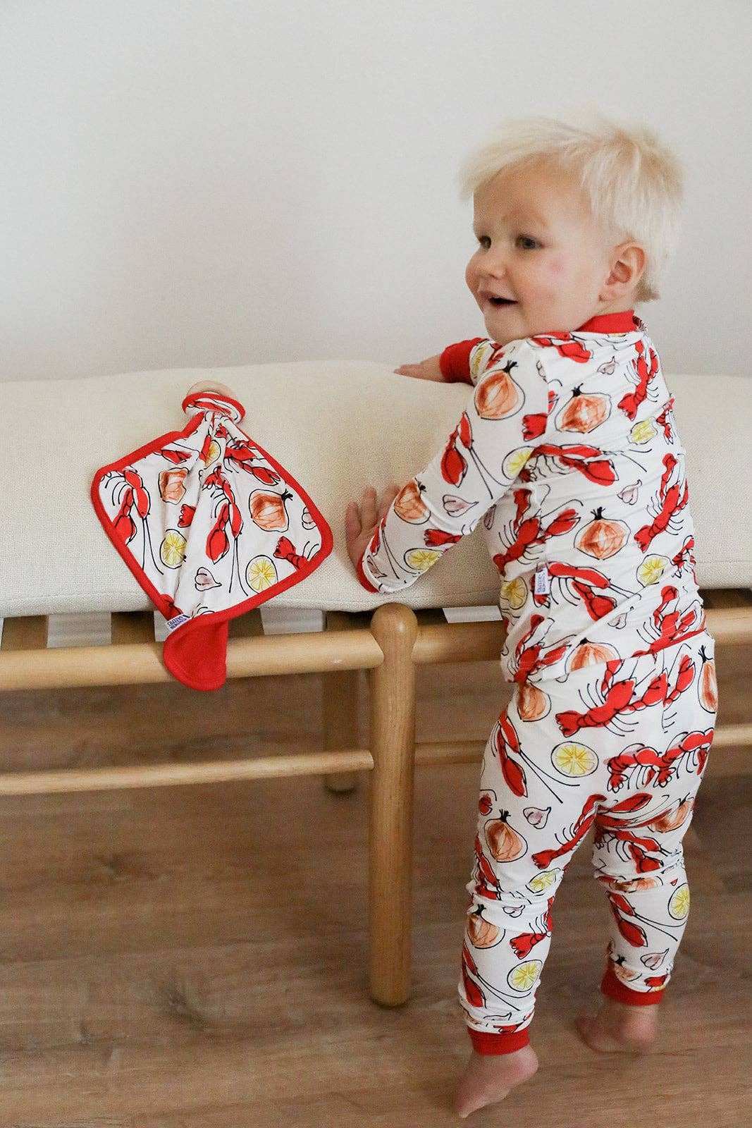 child wearing crawfish pattern pajamas