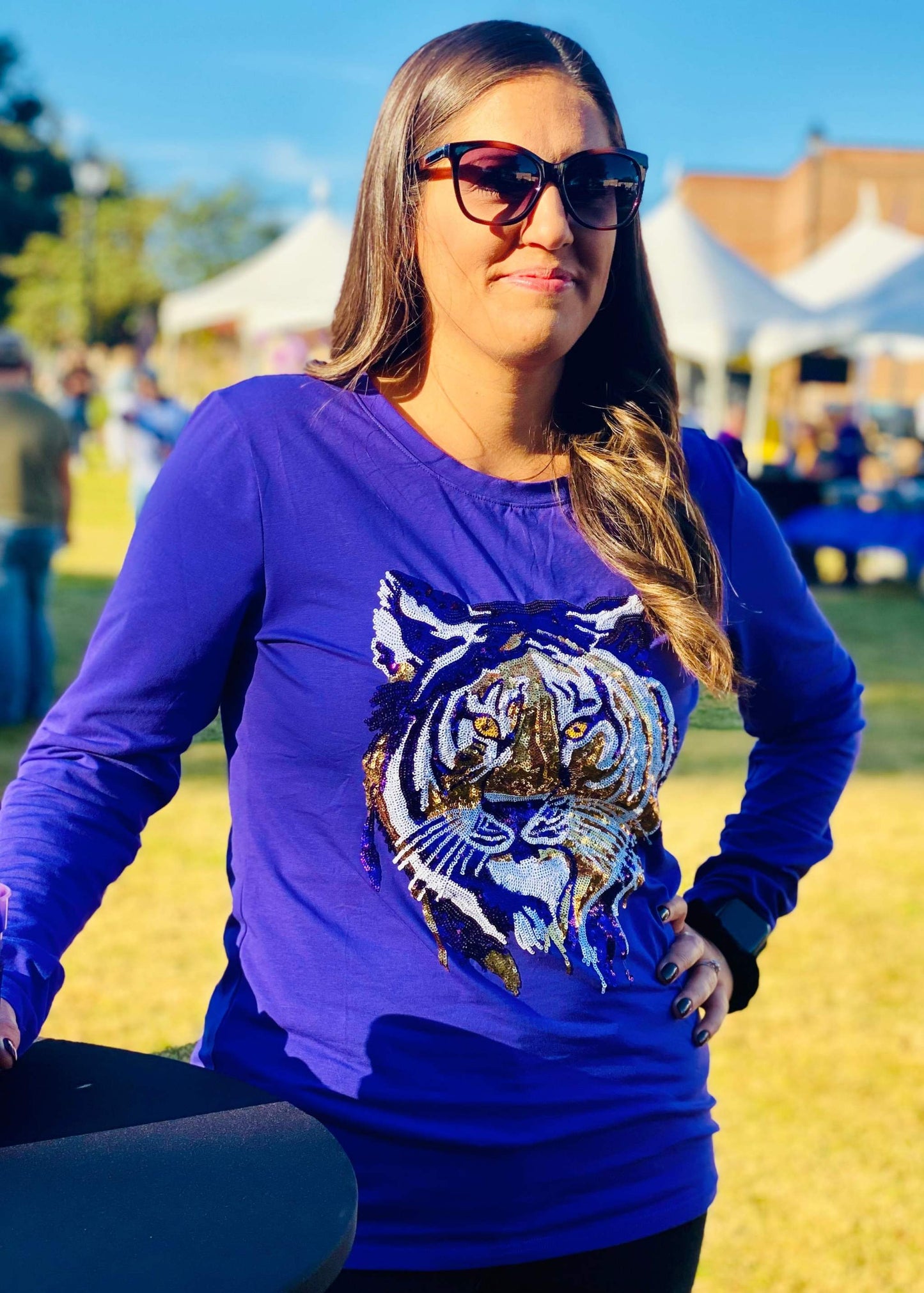 Adult wearing purple Tiger Face long sleeve shirt outdoors