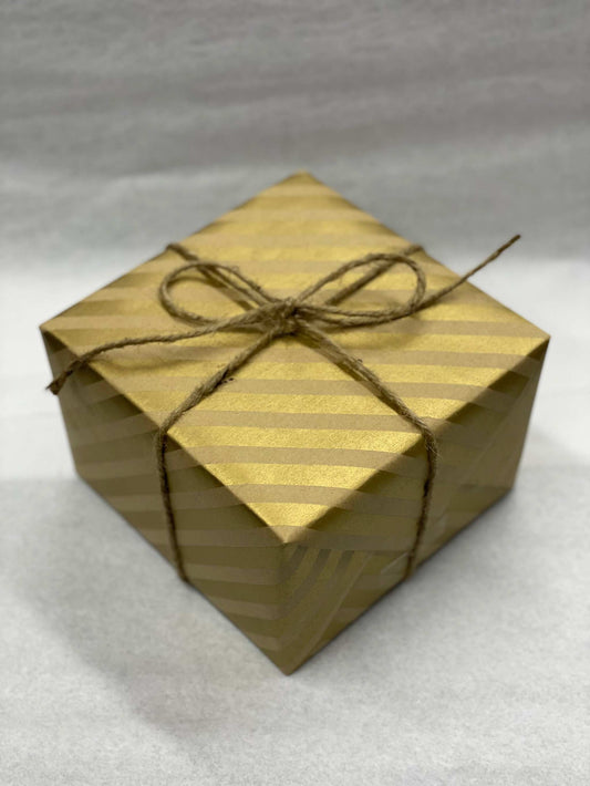 High-quality gift wrapping with a brown ribbon tie.